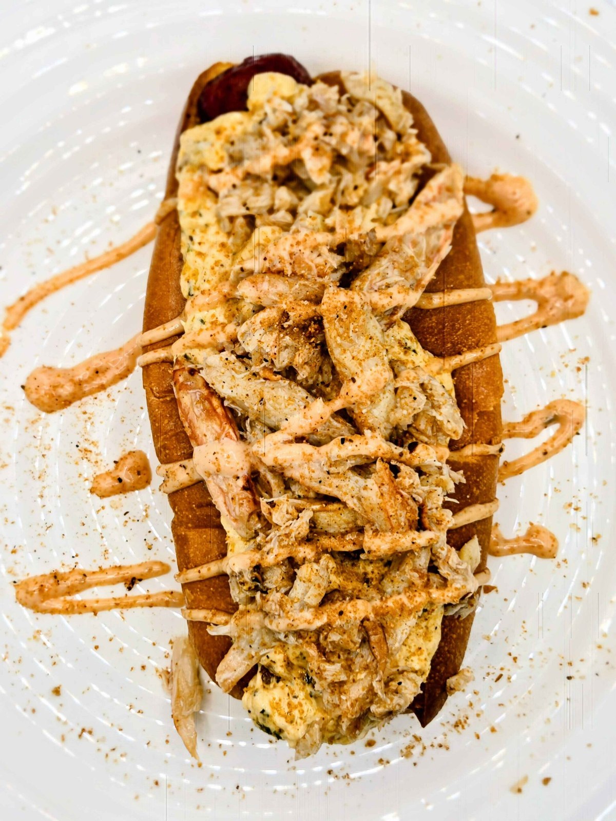 Chilly Dogz Crabby Dog topped with crab dip, crab meat, Pinky Sauce and Old Bay